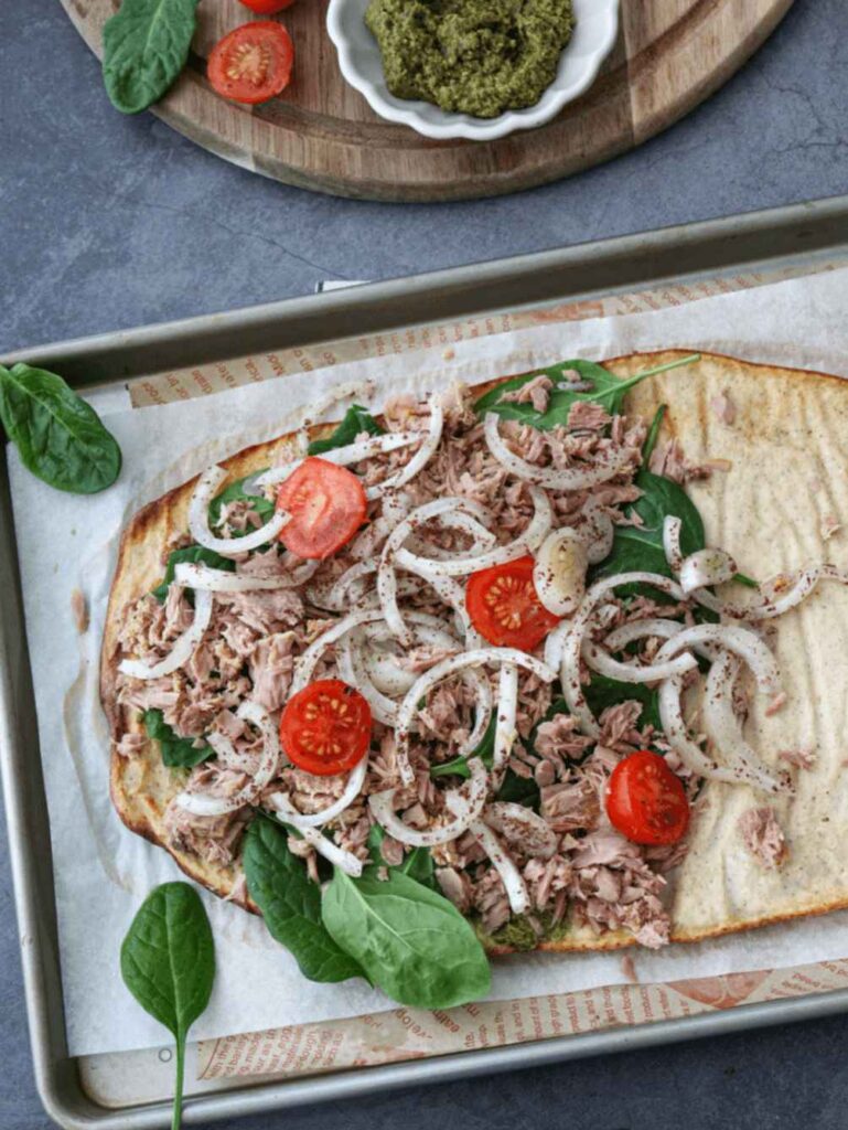 Cottage Cheese Flatbread open wrap with various toppings: tomatoes, onions, spinach and tuna